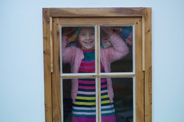 child looks out of window